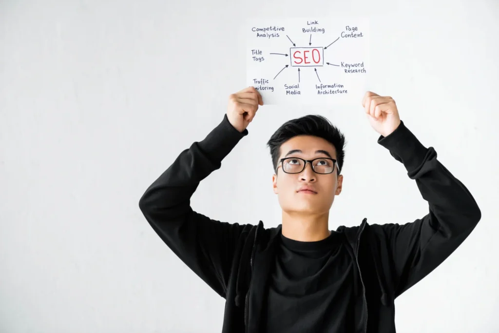 Young SEO specialist holding a technical SEO review diagram with keyword clusters above his head