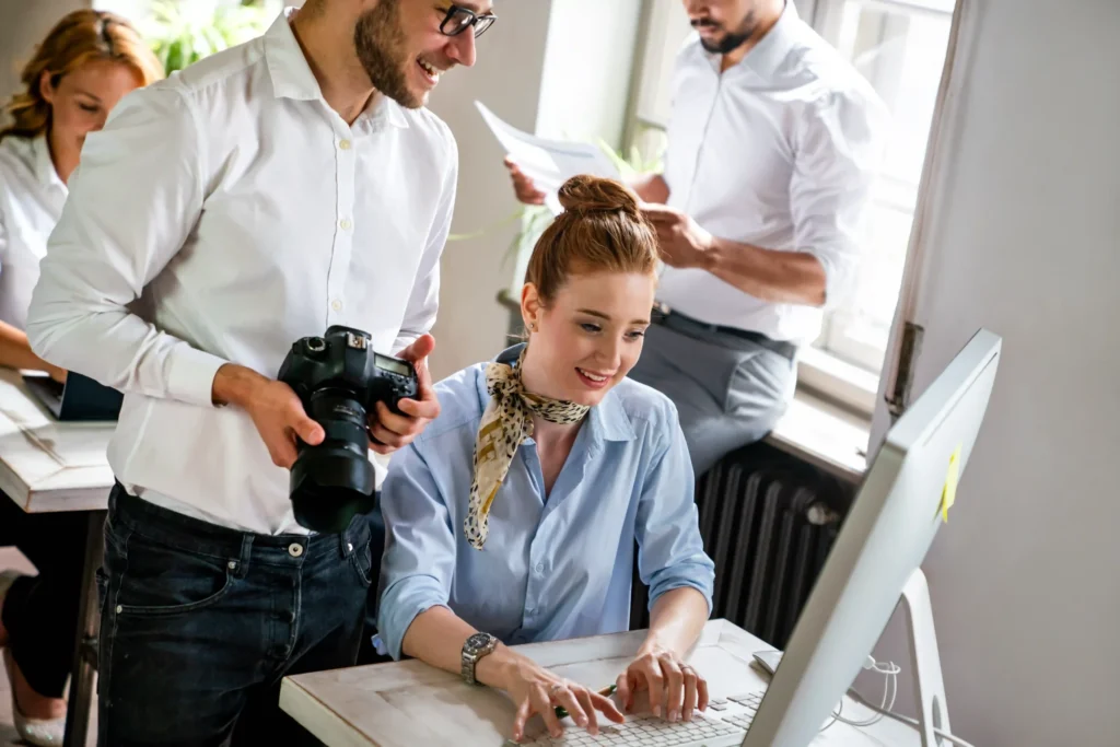 Creative marketing team collaborating on an on page SEO video campaign using desktop editing tools.