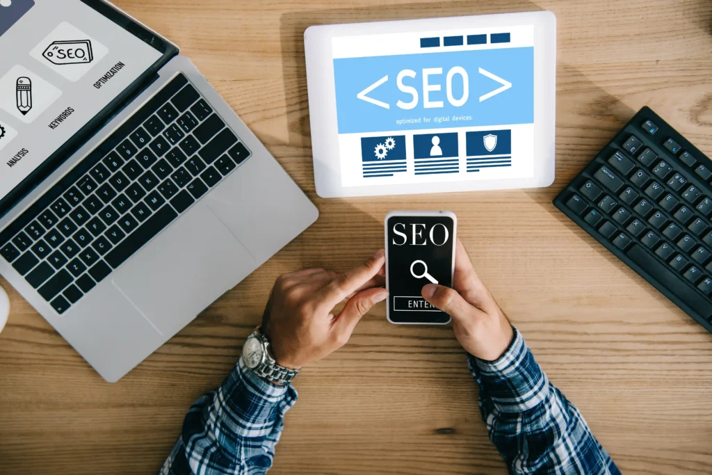 Hands using mobile and tablet displaying Link Building SEO strategies for digital optimization.