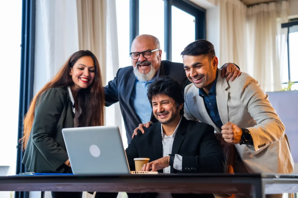 A team of professionals celebrating successful campaign results after implementing on page SEO Rank Math strategies.