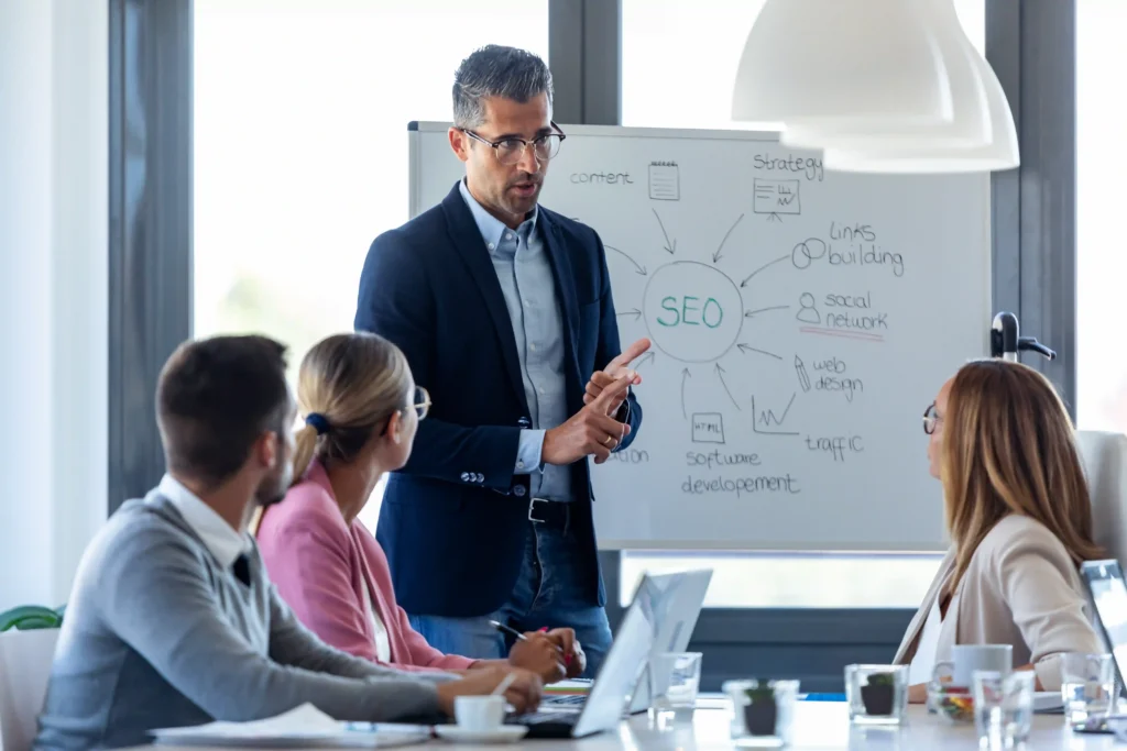 SEO expert leading Enterprise SEO training with team and whiteboard