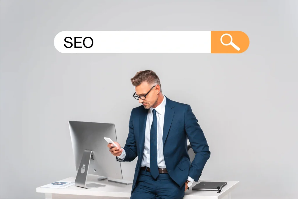 Professional reviewing Enterprise SEO metrics on smartphone at workspace