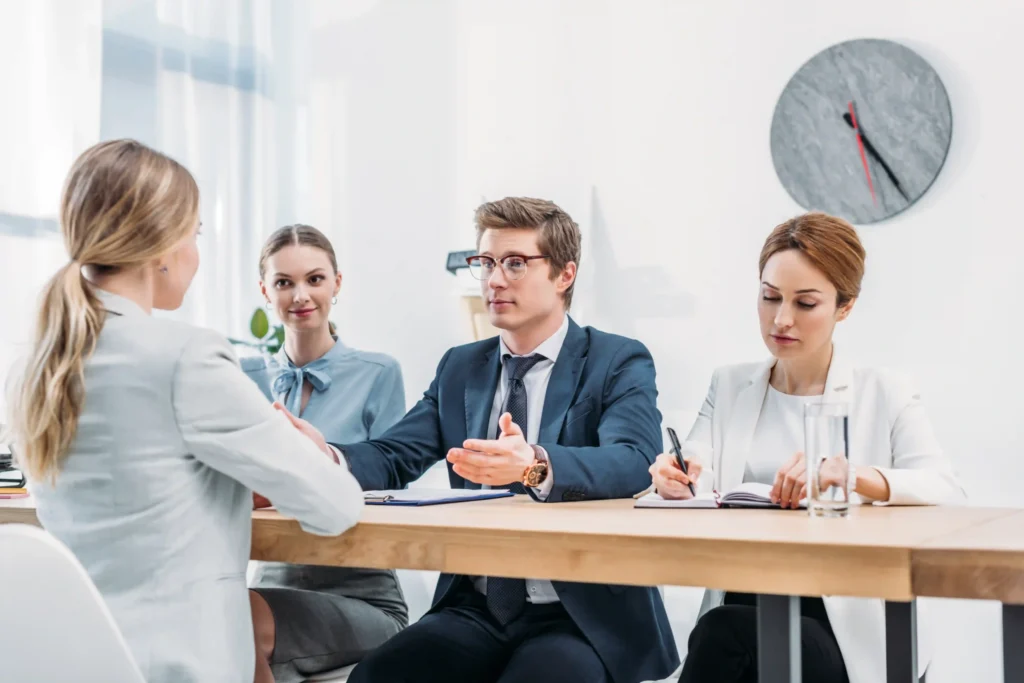 Panel of hiring managers conducting a technical SEO interview with a female candidate