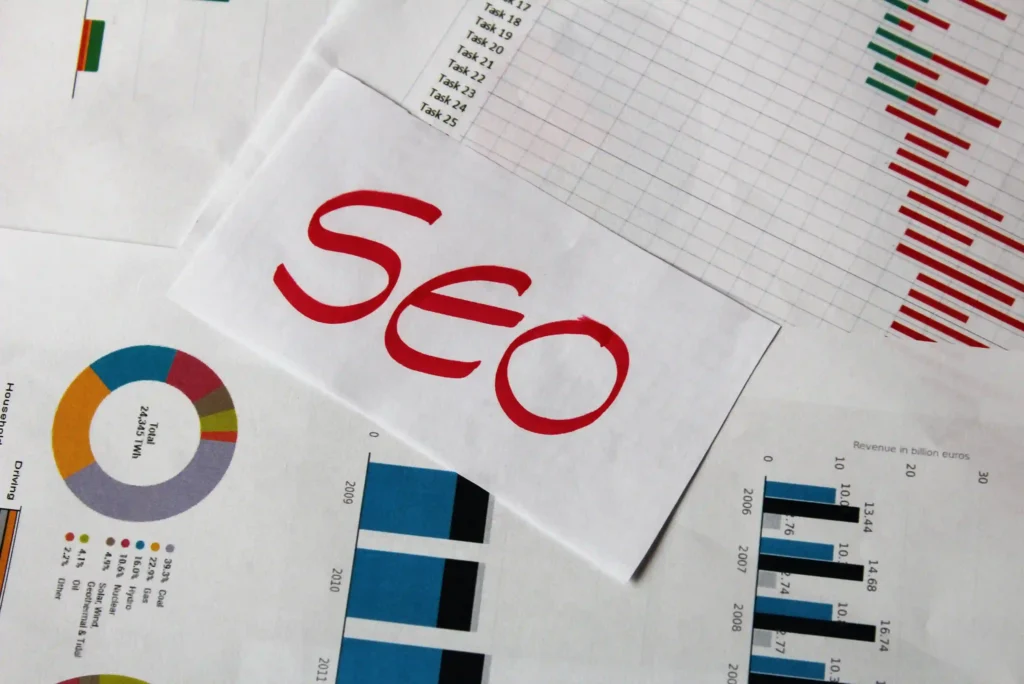 Printed analytics charts and SEO reports illustrating technical SEO work and performance metrics