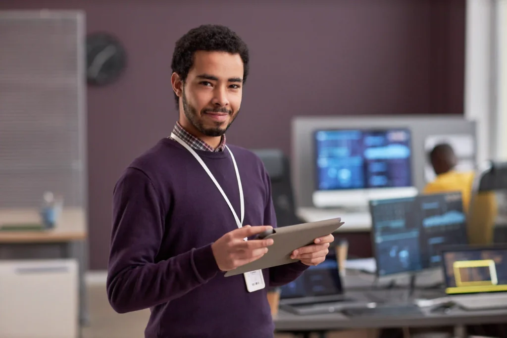 SEO specialist reviewing technical SEO questions and audit data on tablet in a modern workspace.