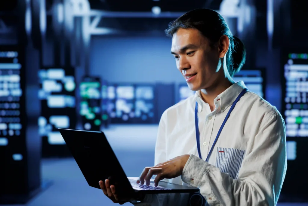 Technical SEO expert managing backend server performance and answering SEO questions on a laptop.
