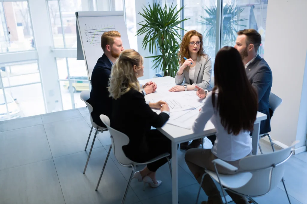 Marketing team in strategic planning session to improve SEO company revenue