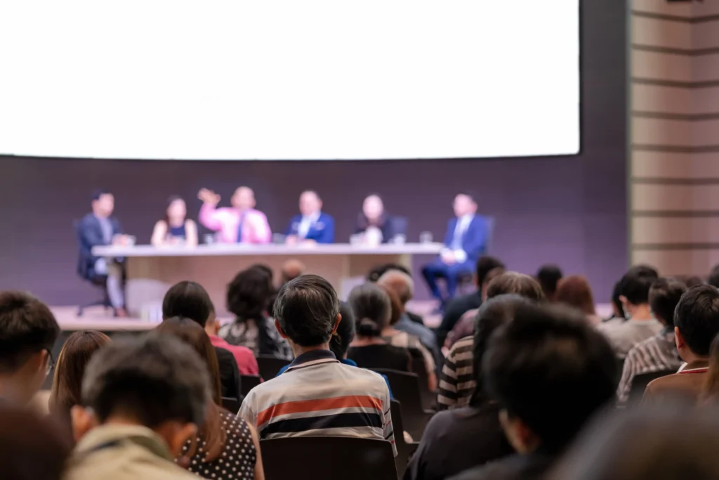 Audience attending a panel at an international SEO conference, focused on expert speakers sharing SEO strategies.