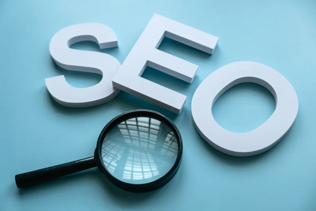 SEO letters with a magnifying glass over blue background representing visibility in seo for marketing campaigns