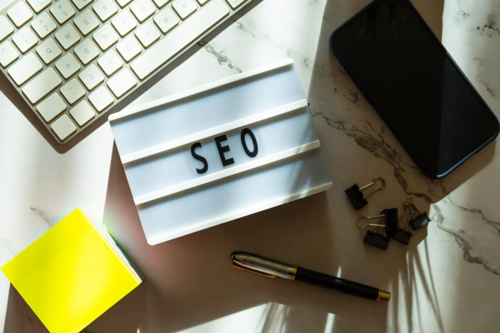SEO sign on lightbox at office desk setup, representing tools for tracking small SEO tools SEO score