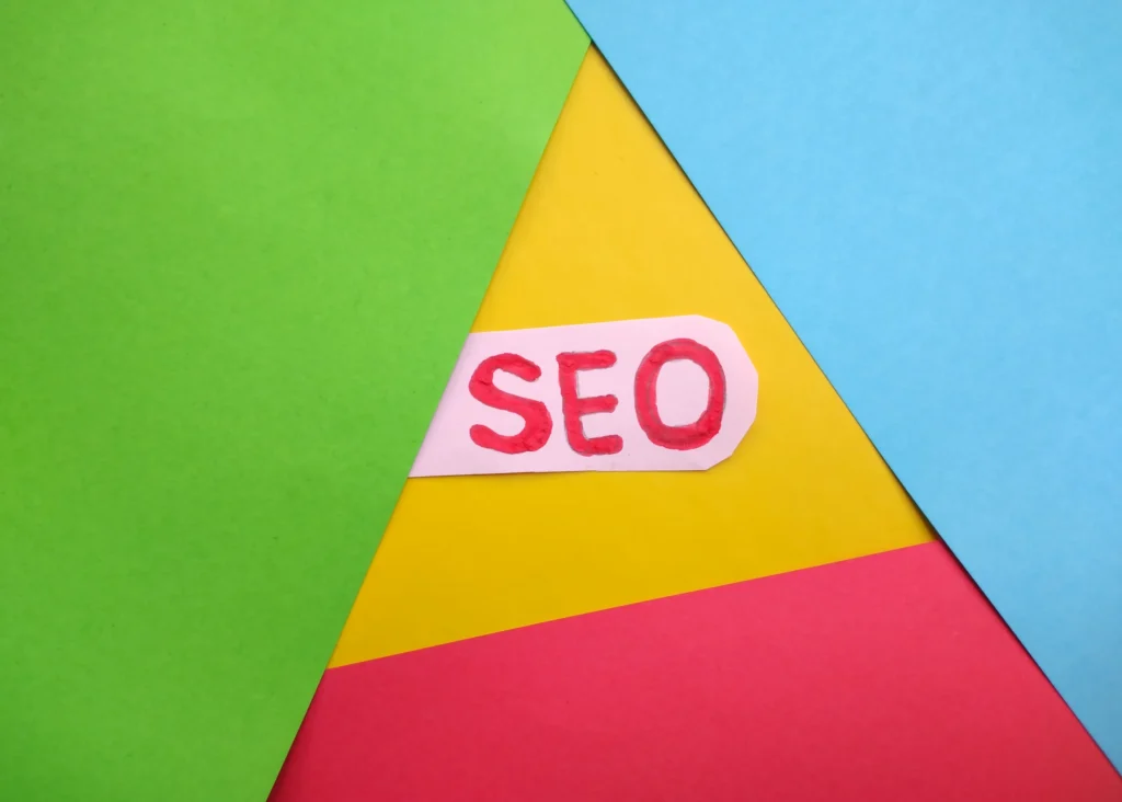 Colorful paper design with the term SEO highlighted, symbolizing creative aspects of enterprise SEO knowledge