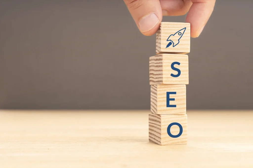 Wooden blocks spelling SEO with rocket icon, symbolizing growth from keyword research techniques SEO