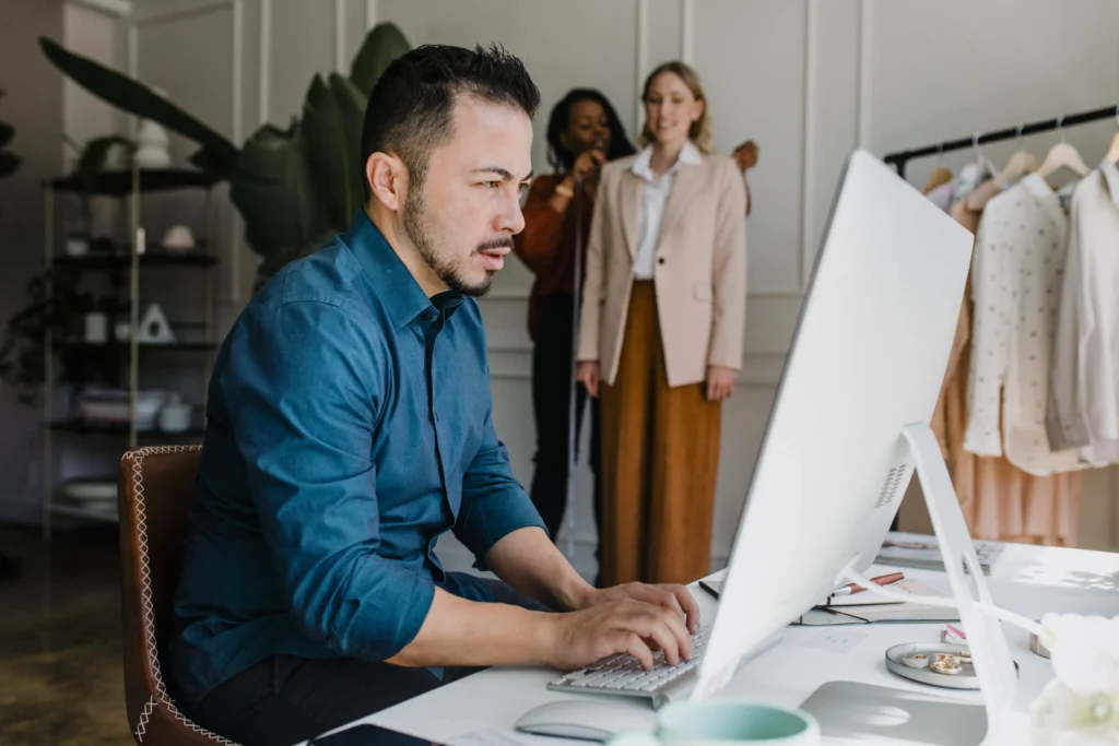 Designer working at a computer, illustrating creative companies using SEO for brand growth.