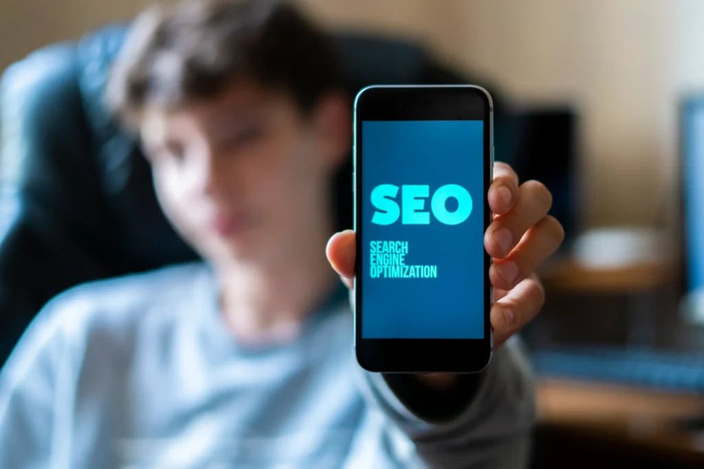 Young professional reviewing analytics on a smartphone, representing companies using SEO to track performance.