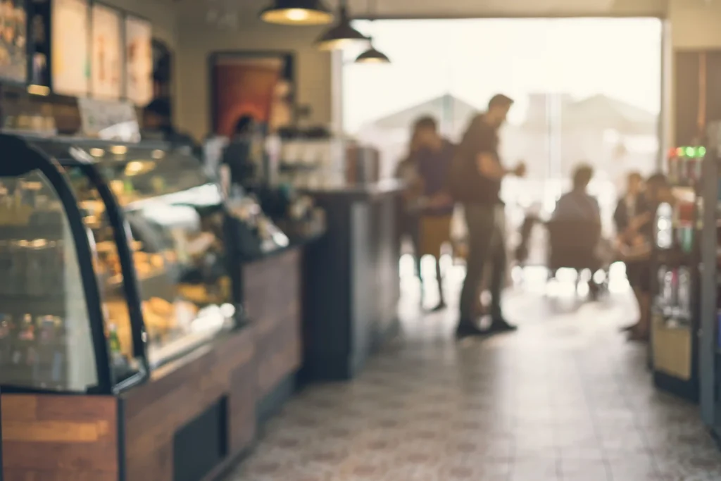 Cozy coffee shop interior filled with customers enjoying drinks, perfect setting for creative coffee campaign ideas.