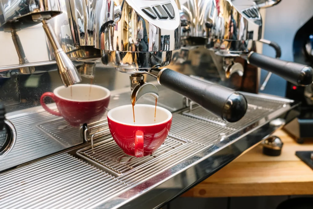 Espresso machine pouring fresh coffee into a red cup, symbolizing craftsmanship and marketing inspiration for coffee campaign ideas.