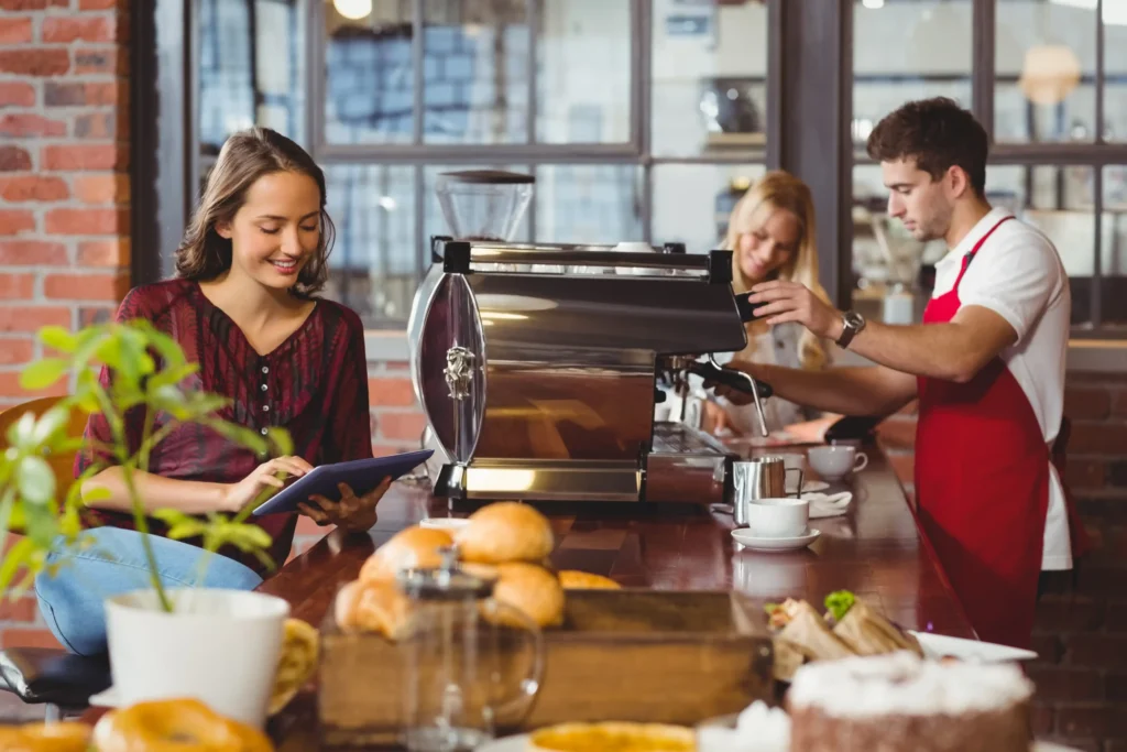 Barista preparing espresso for a customer — great example of personal connection behind effective coffee marketing ideas.