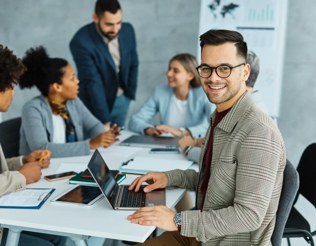 Marketing consultant smiling during a meeting, representing a confident local search marketing expert working with clients.