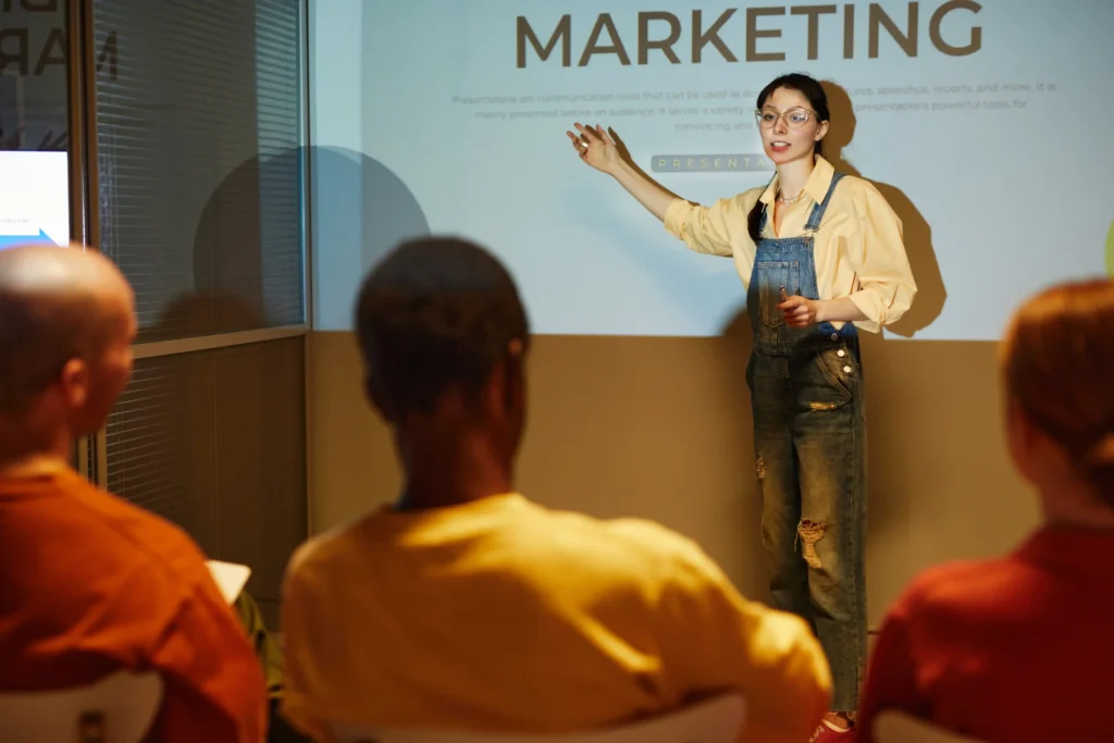 Young presenter explaining marketing concepts during a workshop, symbolizing a skilled local search marketing expert.