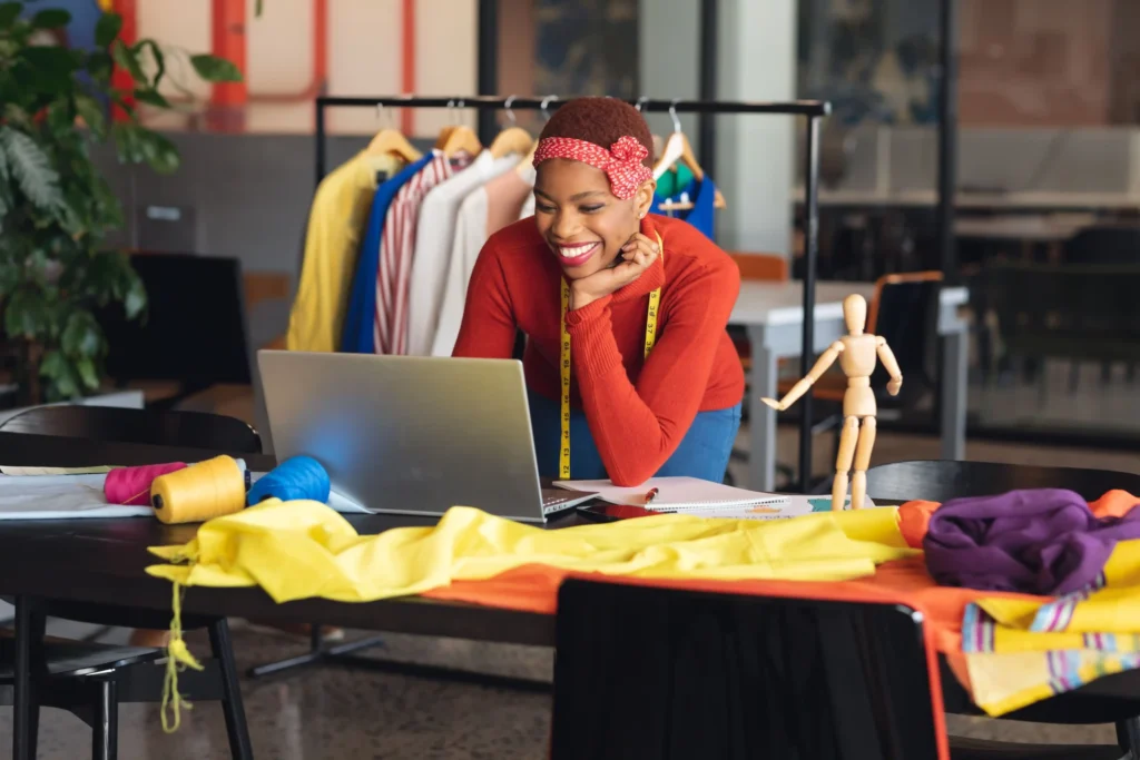 Boutique owner planning new product promotions with an online boutique marketing agency for fashion growth.
