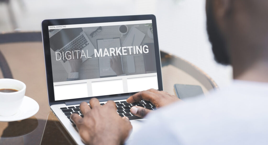 Professional reviewing digital marketing analytics on a laptop, representing companies looking for digital marketing services.