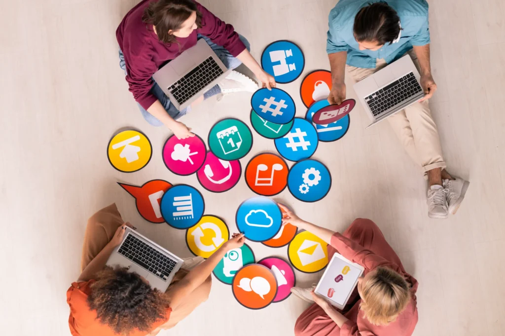A creative marketing team collaborating with colorful social media icons, representing the best digital marketing agency.