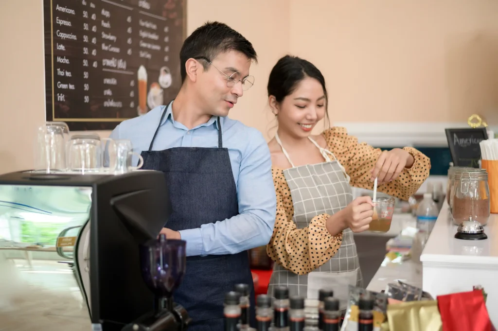 Baristas preparing drinks together in a café, symbolizing teamwork and community success through the local business search engine.