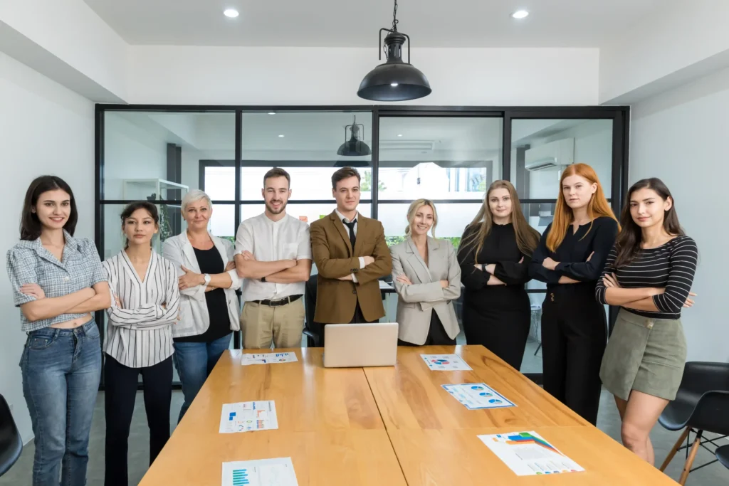 Professional team of marketers at a digital ecommerce branding agency standing confidently in a modern office.