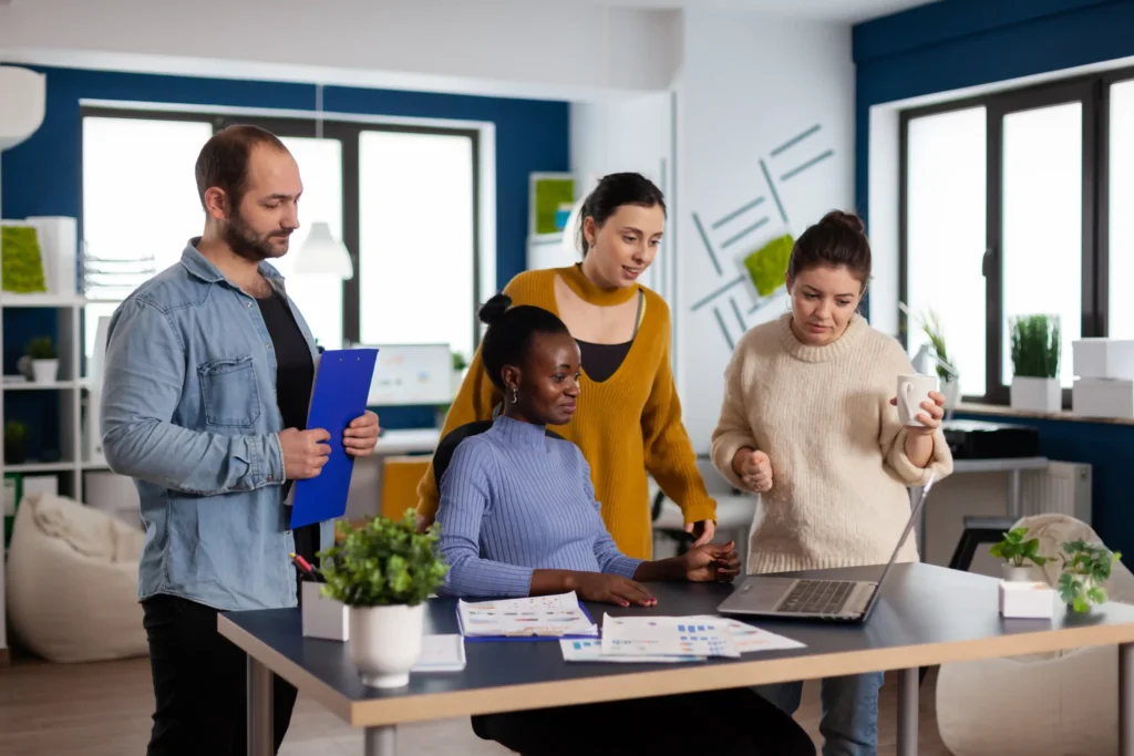 Diverse team collaborating on a project, illustrating how small marketing agencies work closely with clients to create effective marketing strategies.