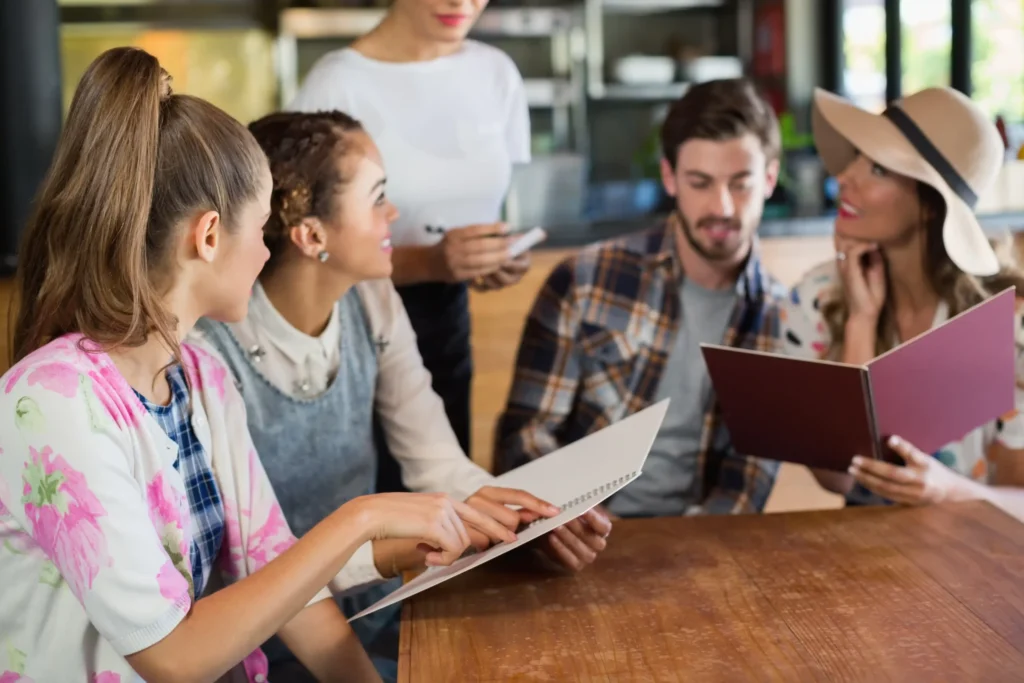 Group of friends ordering food at a restaurant representing connection and storytelling in a social media strategy for restaurant.