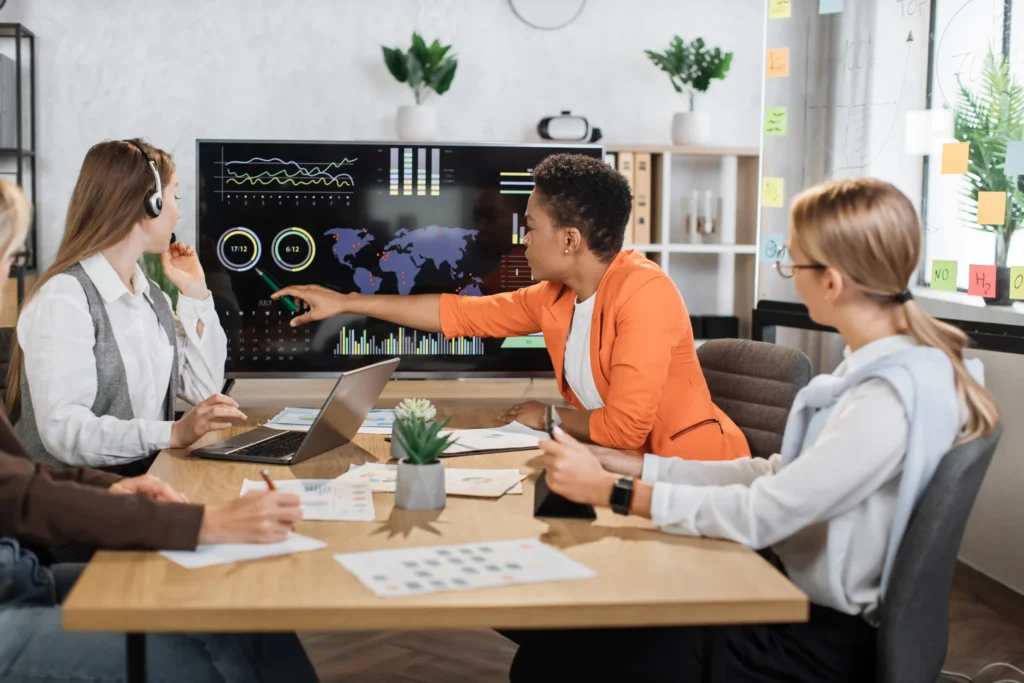 Marketing team reviewing analytics dashboard to plan strategies for local SEO for agencies.