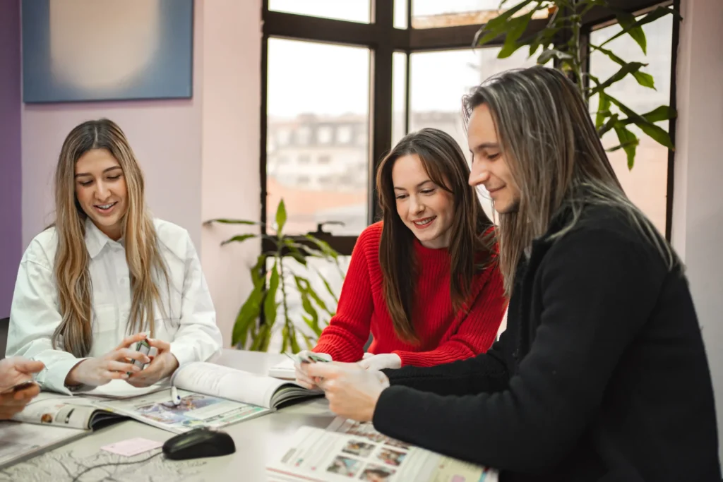 Creative team reviewing marketing materials together, reflecting the personalized, hands-on approach of small marketing agencies.