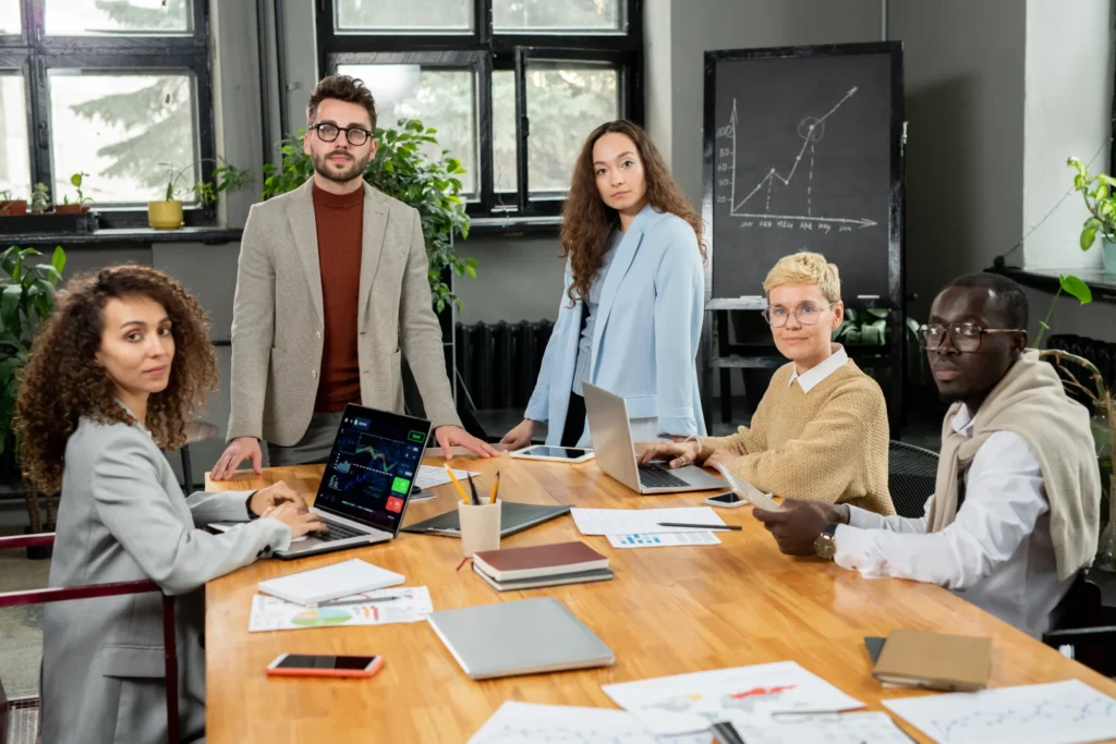 Group of professionals in a modern office working on branding strategy and digital marketing plans for an online branding agency.