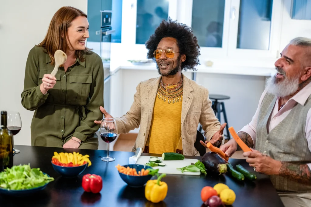 Group of friends cooking and enjoying a meal, representing community and lifestyle concepts for food marketing ideas and social campaigns.