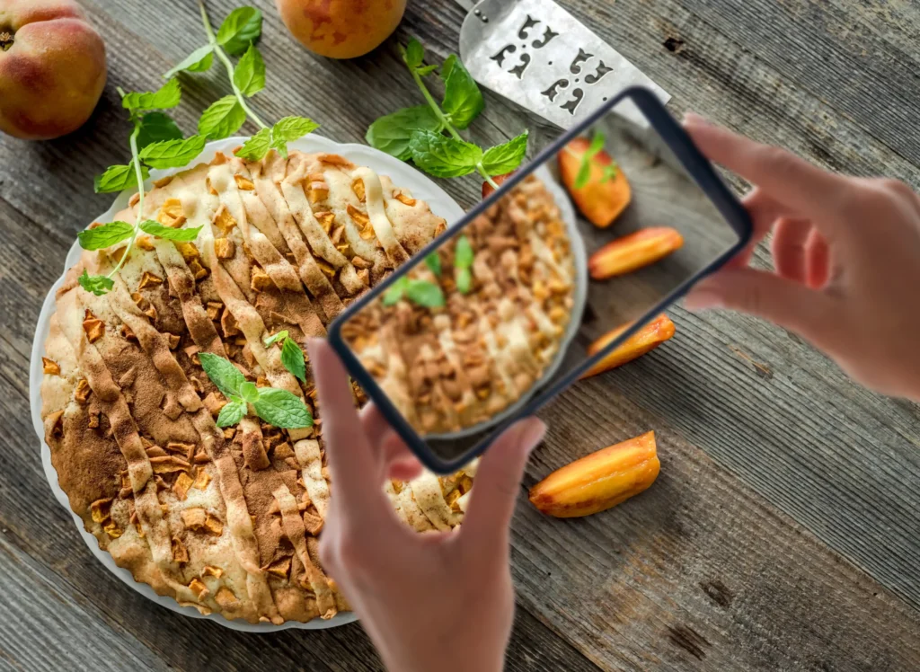 Overhead shot of peach pie being photographed for content creation in food digital marketing.