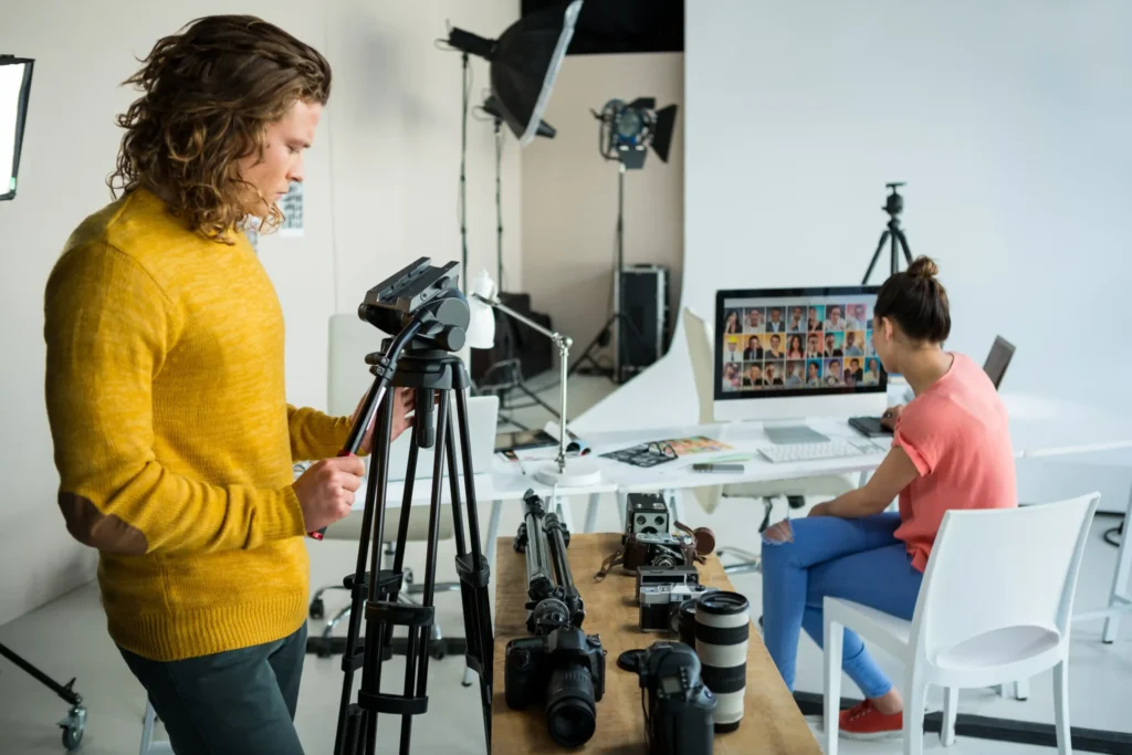 Photographers and editors working together in a studio setting at a content production agency.