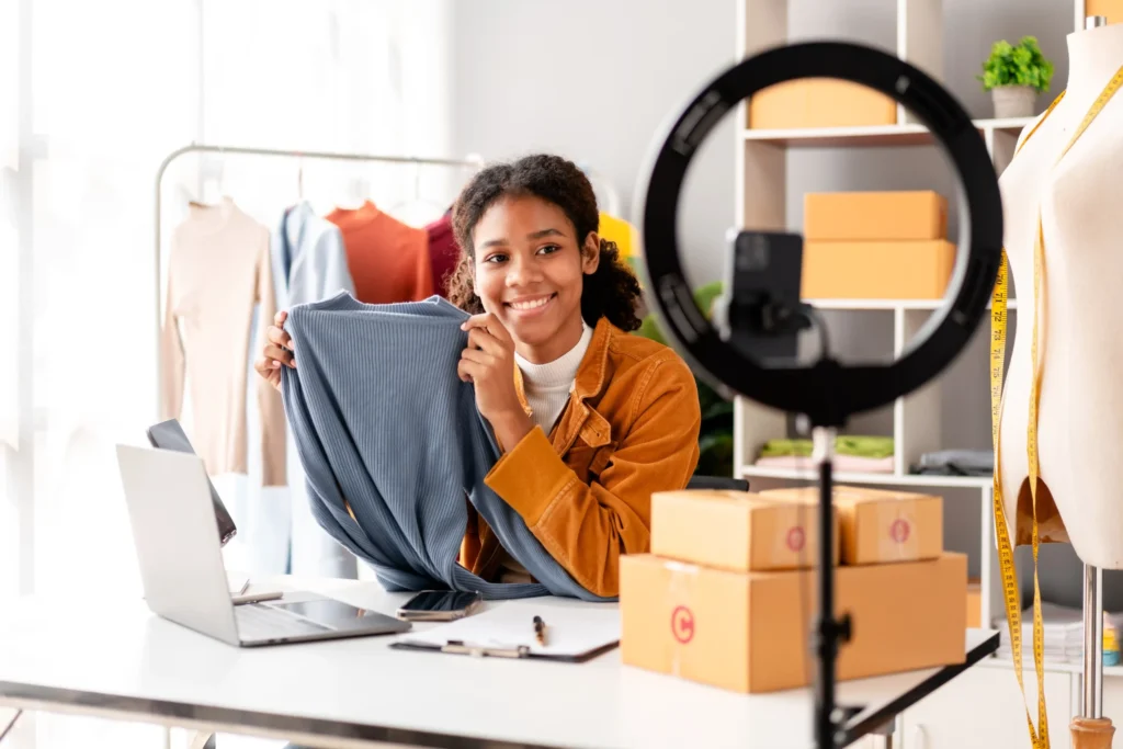 Young designer promoting a new outfit through social media content created by an online boutique marketing agency.