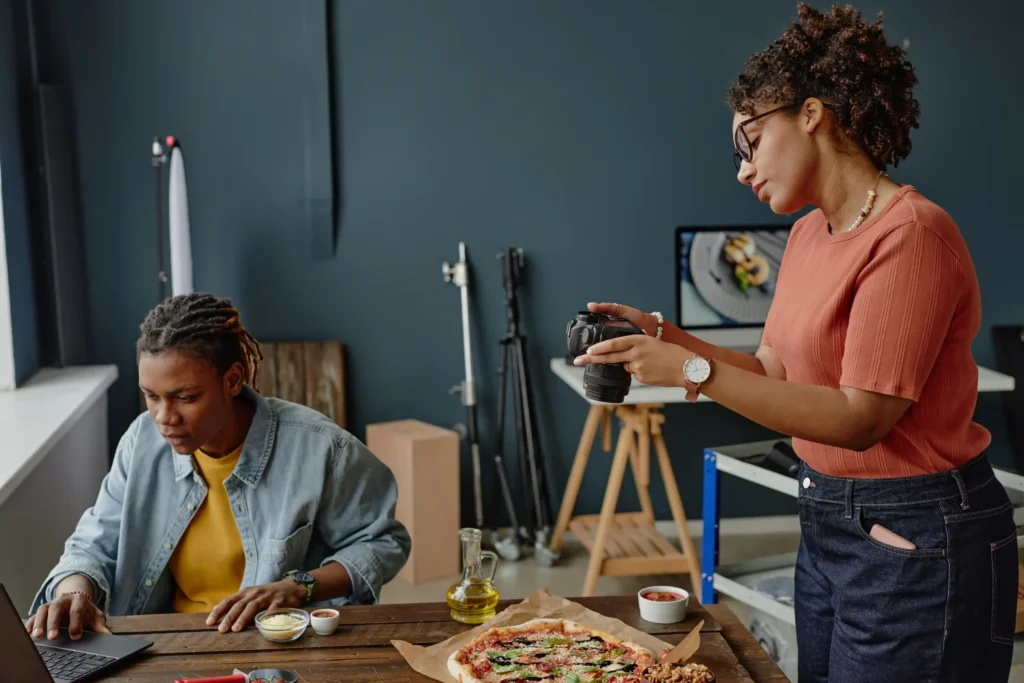 Photographer capturing fresh pizza content for a digital campaign by a restaurant marketing agency near me.
