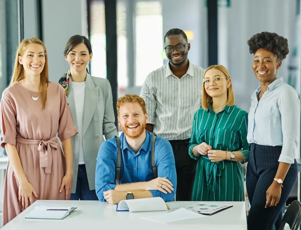 A diverse marketing team smiling during a strategy meeting, reflecting the approach of the best local SEO company for Google.