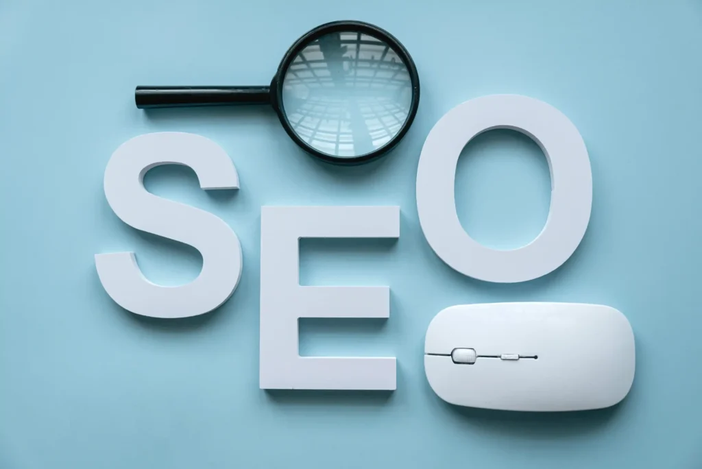 White SEO letters with a magnifying glass and computer mouse symbolizing research and evaluation of local seo services pricing.