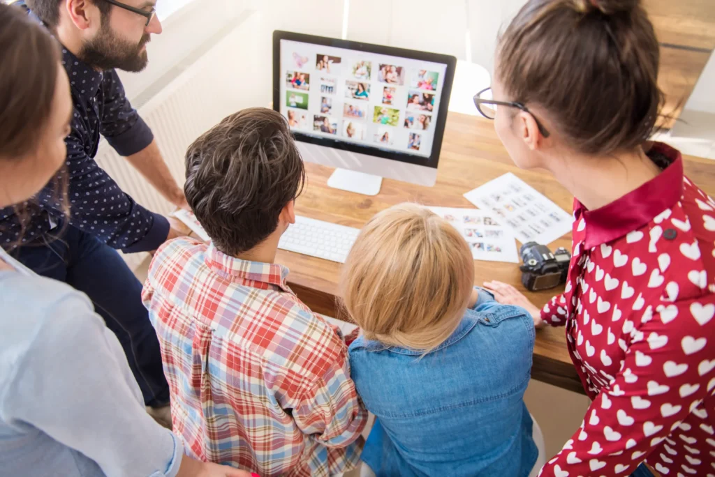 Marketing team reviewing campaign visuals on a computer as part of planning the best online marketing strategies.