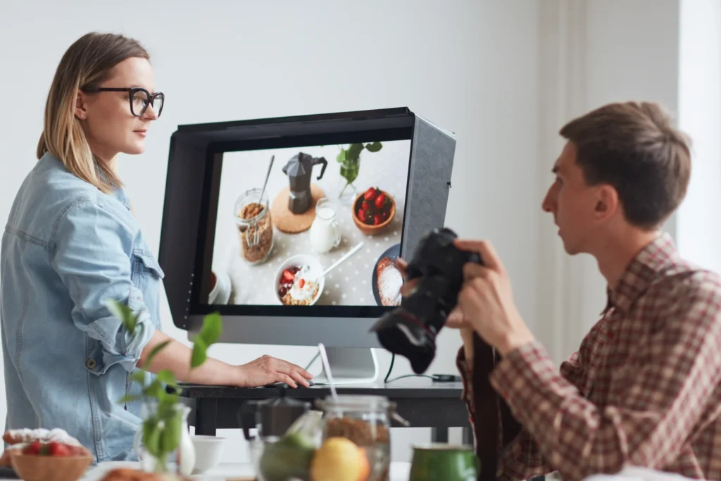Paid advertising agency team reviewing creative assets and campaign visuals during a professional marketing strategy session