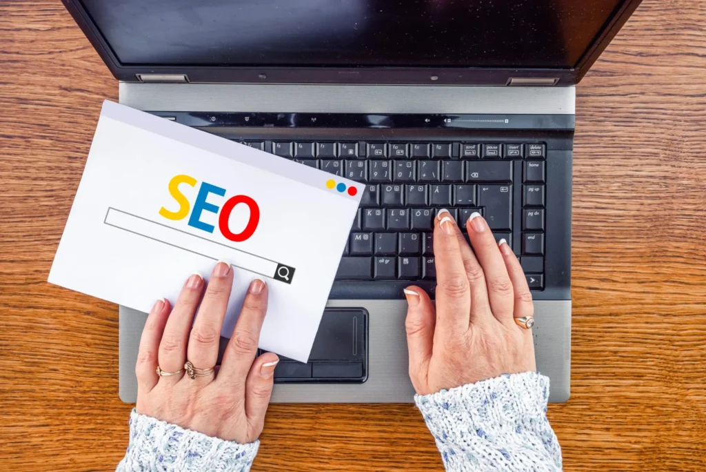 Hands performing best local seo research using search engine optimization tools on laptop